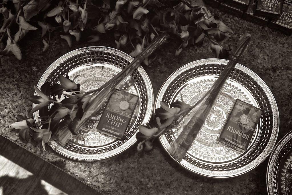 Wat Bang Phra Temple offering - flowers and ... cigarettes